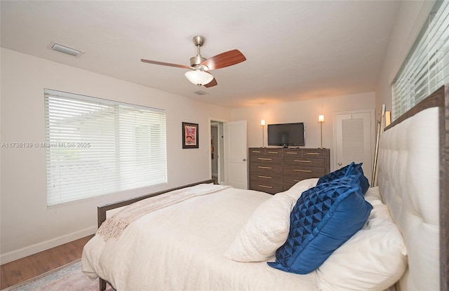 bedroom with wood-type flooring and ceiling fan