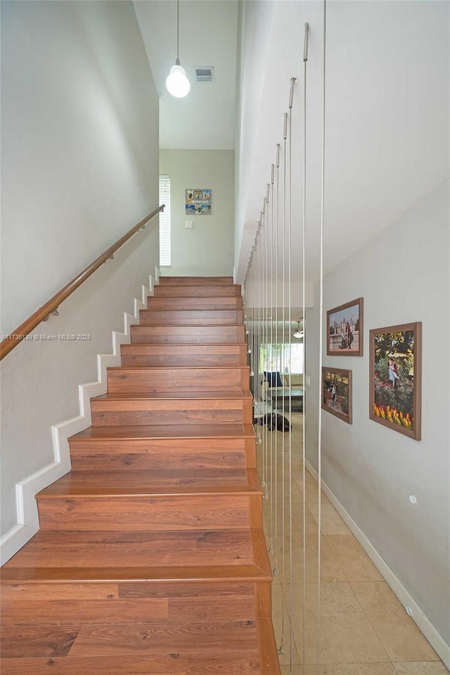 staircase with tile patterned floors