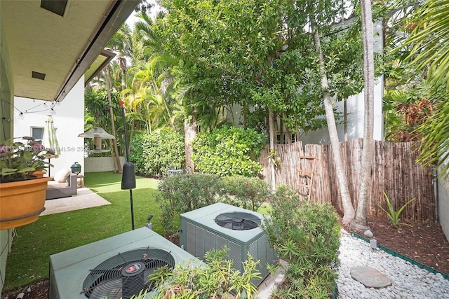 view of yard featuring central AC and a patio