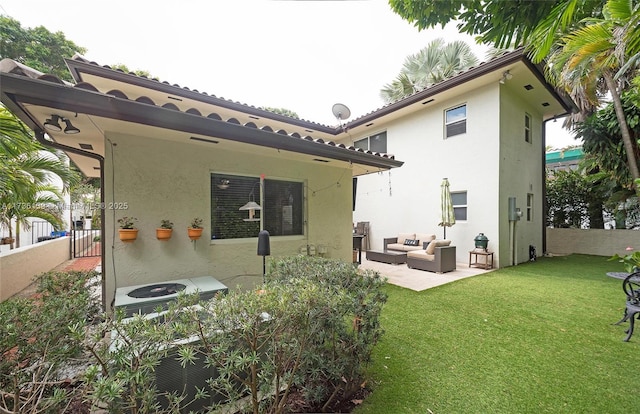 rear view of house with an outdoor living space, a patio, a yard, and central AC