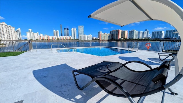 view of pool featuring a water view and a patio