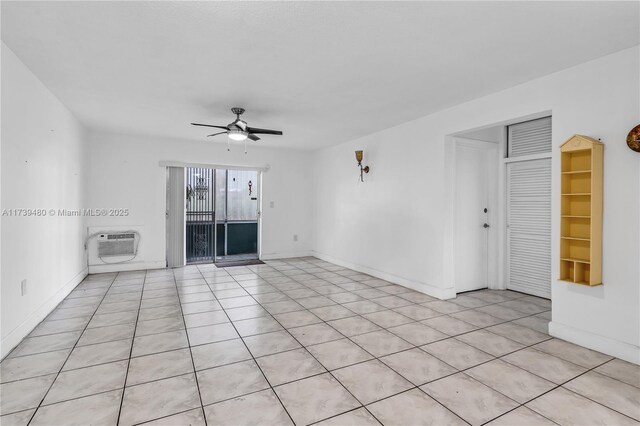 unfurnished living room with an AC wall unit, light tile patterned floors, and ceiling fan