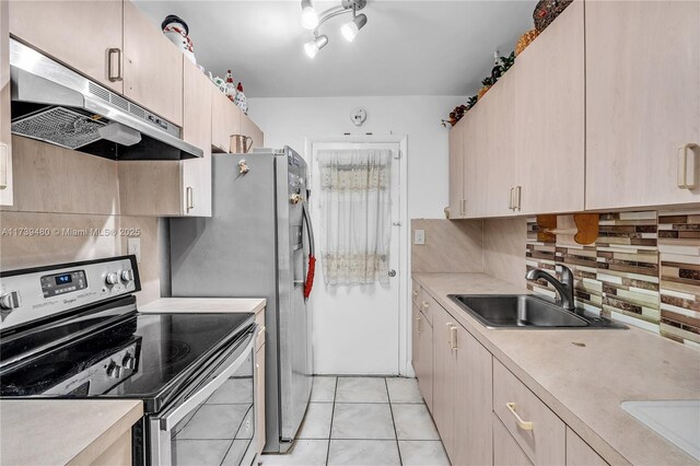 kitchen with stainless steel electric range oven, tasteful backsplash, sink, light tile patterned floors, and light brown cabinets