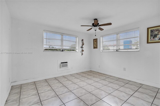 spare room featuring ceiling fan and an AC wall unit