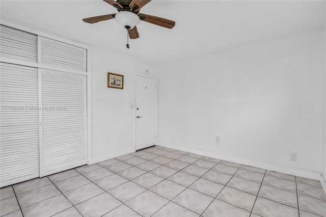 interior space with ceiling fan and a closet