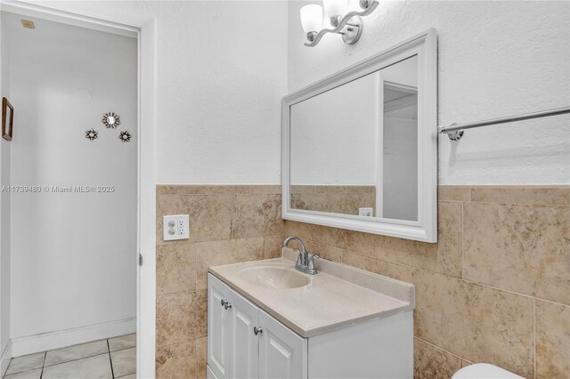 bathroom featuring vanity, tile walls, and tile patterned floors