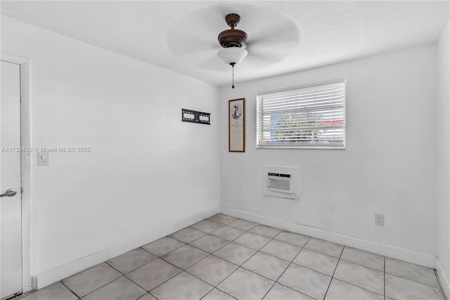 empty room featuring a textured ceiling, an AC wall unit, and ceiling fan