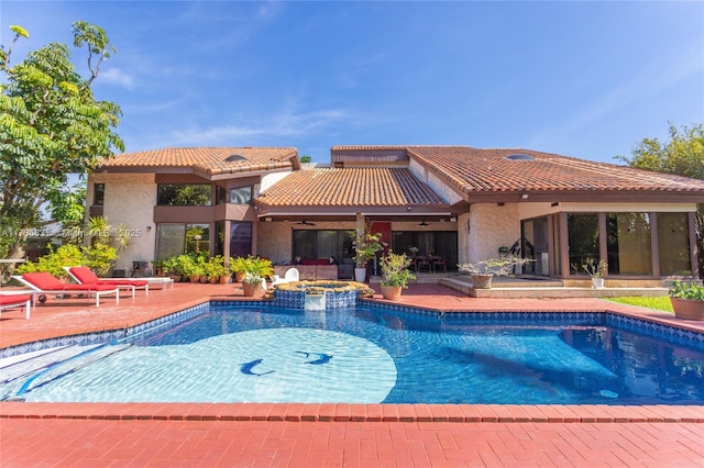 view of pool featuring a patio, ceiling fan, and an in ground hot tub