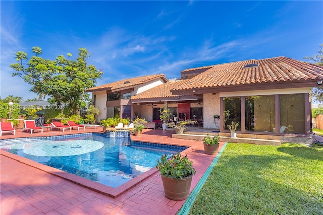 view of pool with a patio and a yard