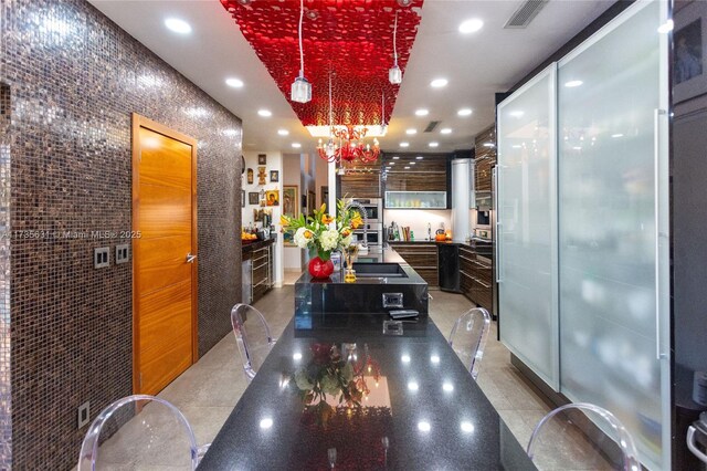 kitchen featuring decorative light fixtures and tile patterned flooring