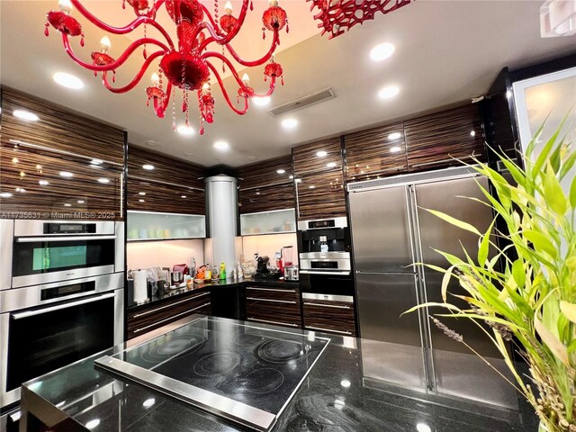 kitchen featuring stainless steel built in refrigerator and stovetop