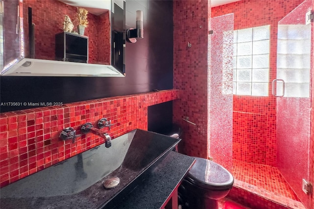 bathroom with tile walls, sink, and toilet