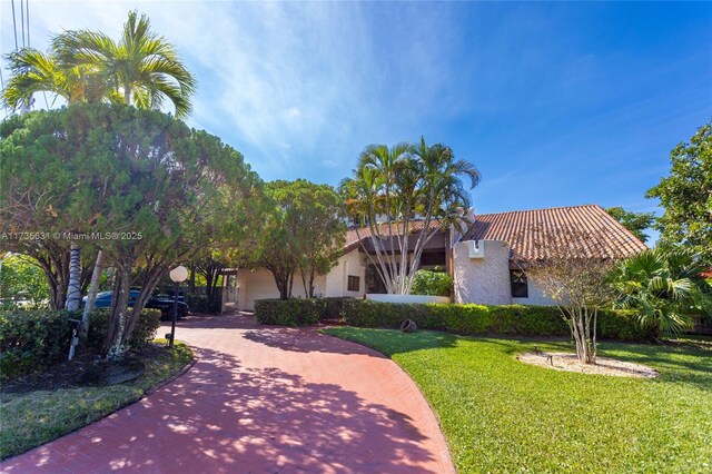 mediterranean / spanish-style home featuring a front lawn