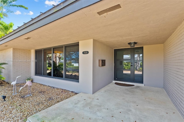 doorway to property featuring a patio area and french doors