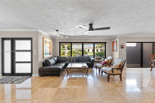 living room featuring ceiling fan, ornamental molding, and a textured ceiling