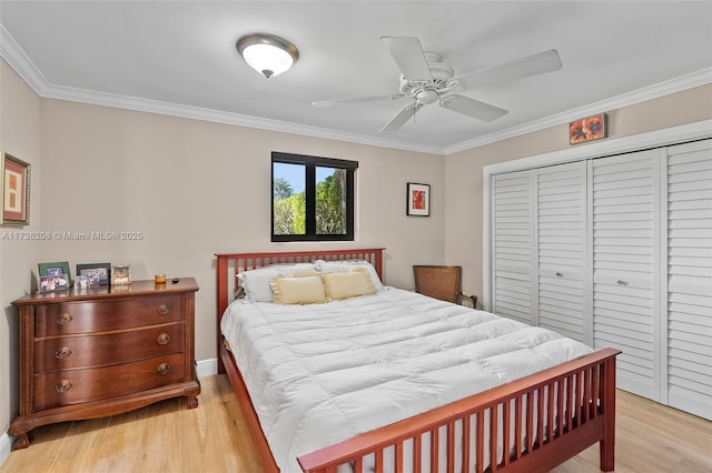 bedroom with crown molding, light hardwood / wood-style floors, and a closet