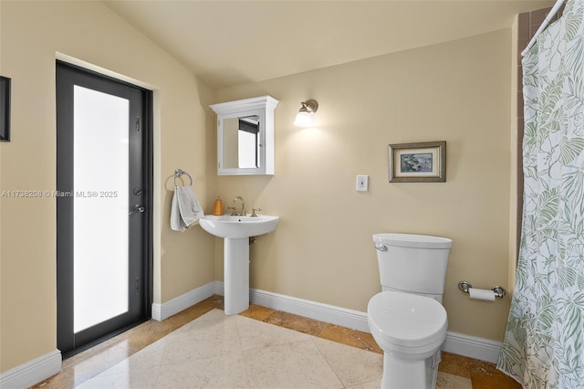 bathroom featuring a shower with shower curtain, tile patterned floors, toilet, and vaulted ceiling