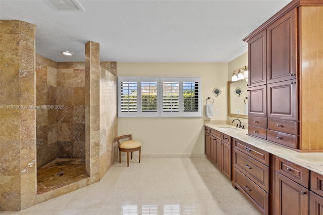 bathroom featuring vanity and a tile shower