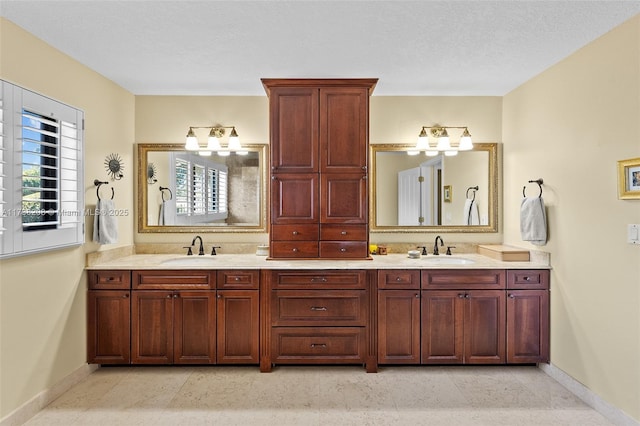 bathroom with vanity, tile patterned floors, and a textured ceiling