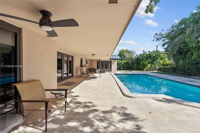 view of pool with a patio and ceiling fan