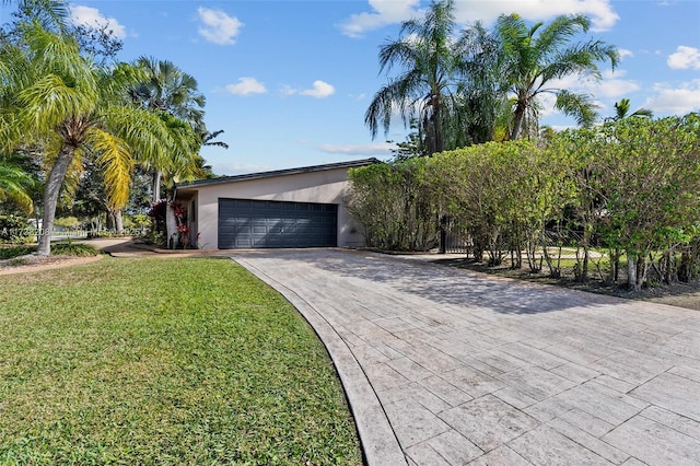 view of front of home featuring a garage and a front lawn