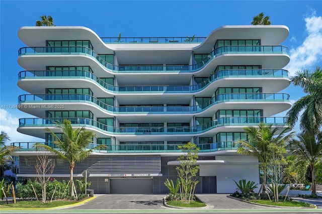 view of building exterior featuring driveway and an attached garage