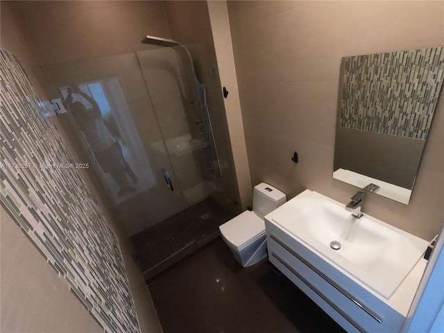 bathroom with toilet, tile walls, vanity, and walk in shower