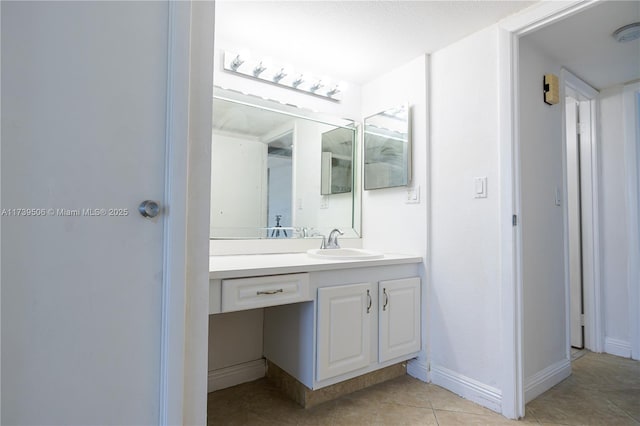 bathroom with tile patterned floors and vanity