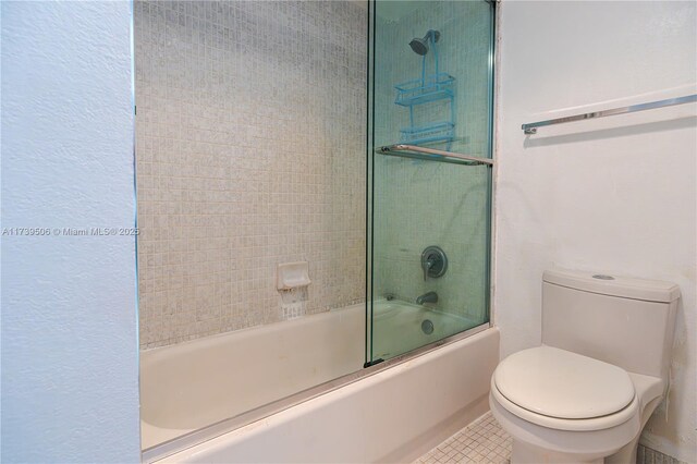 bathroom with tile patterned floors, enclosed tub / shower combo, and toilet