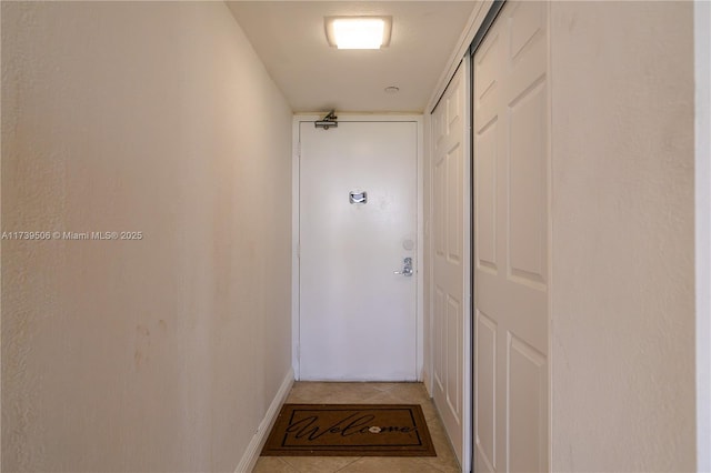 corridor with light tile patterned floors