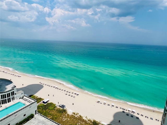 birds eye view of property with a water view and a view of the beach