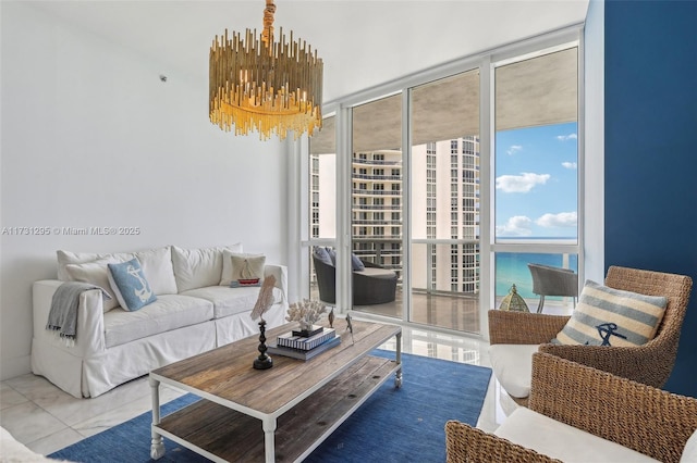 living room featuring expansive windows, a water view, tile patterned floors, and an inviting chandelier