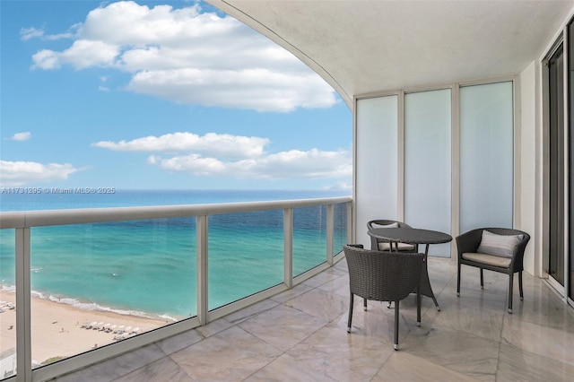 balcony with a view of the beach and a water view