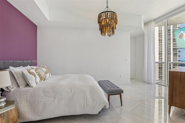 bedroom with a chandelier and floor to ceiling windows