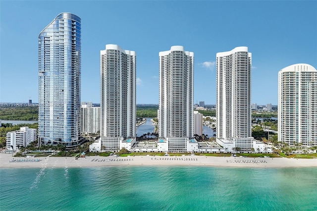 bird's eye view featuring a water view, a view of city, and a beach view