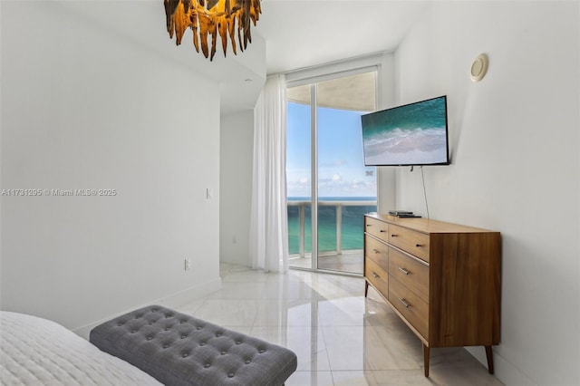 bedroom featuring expansive windows, baseboards, and access to exterior