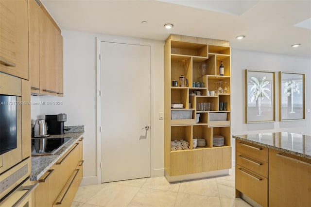 kitchen featuring light tile patterned floors, dark stone countertops, black electric stovetop, light brown cabinetry, and recessed lighting