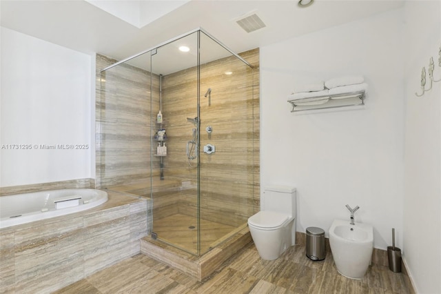 full bathroom featuring a garden tub, visible vents, toilet, a bidet, and a shower stall