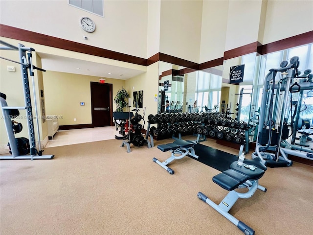 workout area with visible vents and a towering ceiling