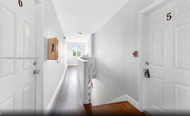 hallway with dark hardwood / wood-style floors