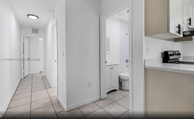 corridor featuring light tile patterned floors