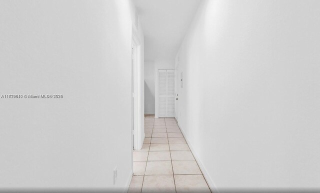 hallway featuring light tile patterned floors