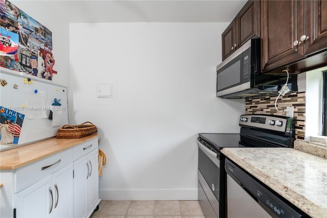 kitchen with white cabinetry, backsplash, light tile patterned floors, stainless steel appliances, and dark brown cabinets