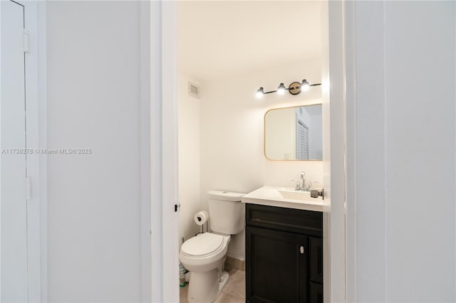 bathroom with vanity, tile patterned floors, and toilet