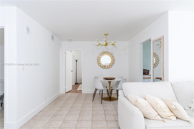 living room featuring light tile patterned flooring and a chandelier