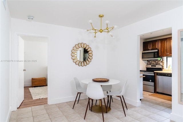 tiled dining space featuring a chandelier