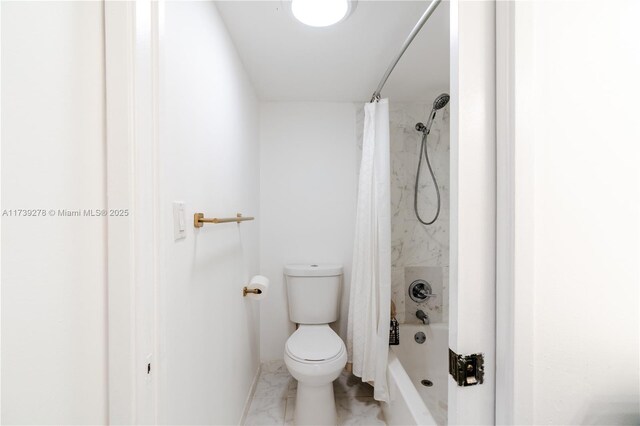 bathroom with shower / bath combo and toilet