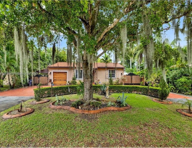 view of front facade with a garage and a front lawn