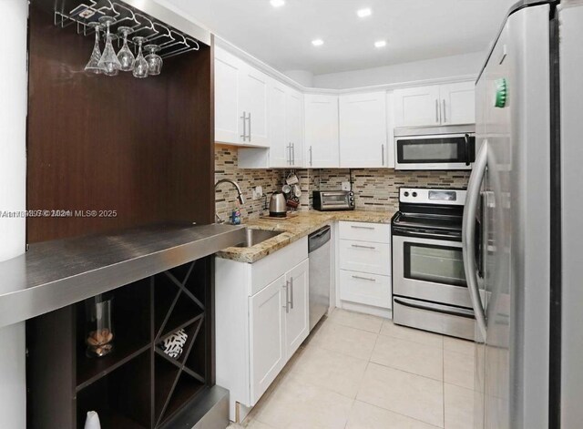 kitchen with sink, stainless steel appliances, and white cabinets