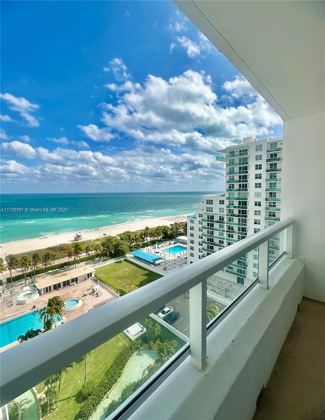 balcony with a beach view and a water view